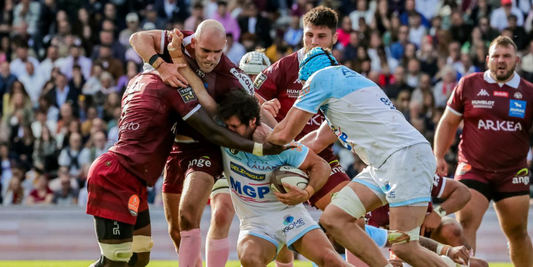 Top 14 Round 16 rugby match action – Bordeaux-Bègles players tackling a Bayonne ball carrier in a physical contest during the 2025 French rugby season.