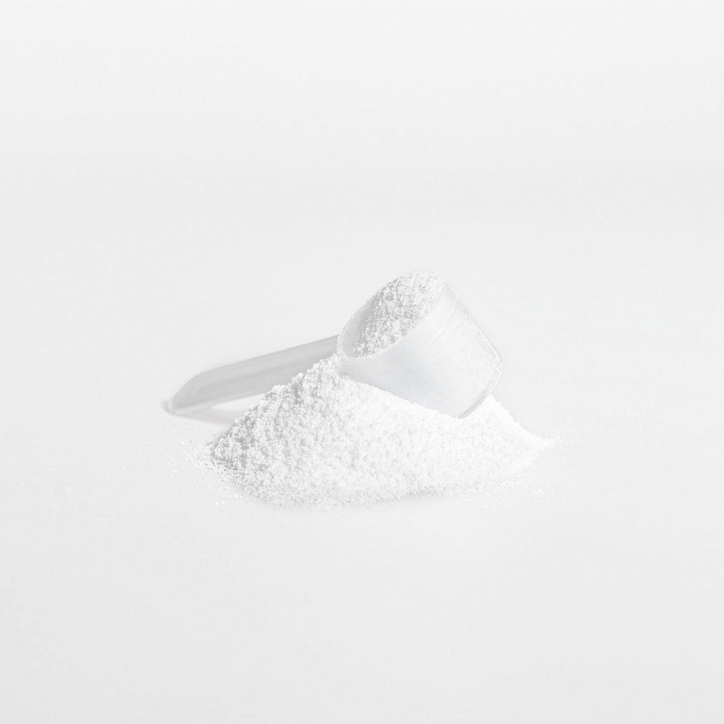  Close-up image of PERFORM Creatine Monohydrate powder with a clear plastic scoop, showing fine white powder supplement.