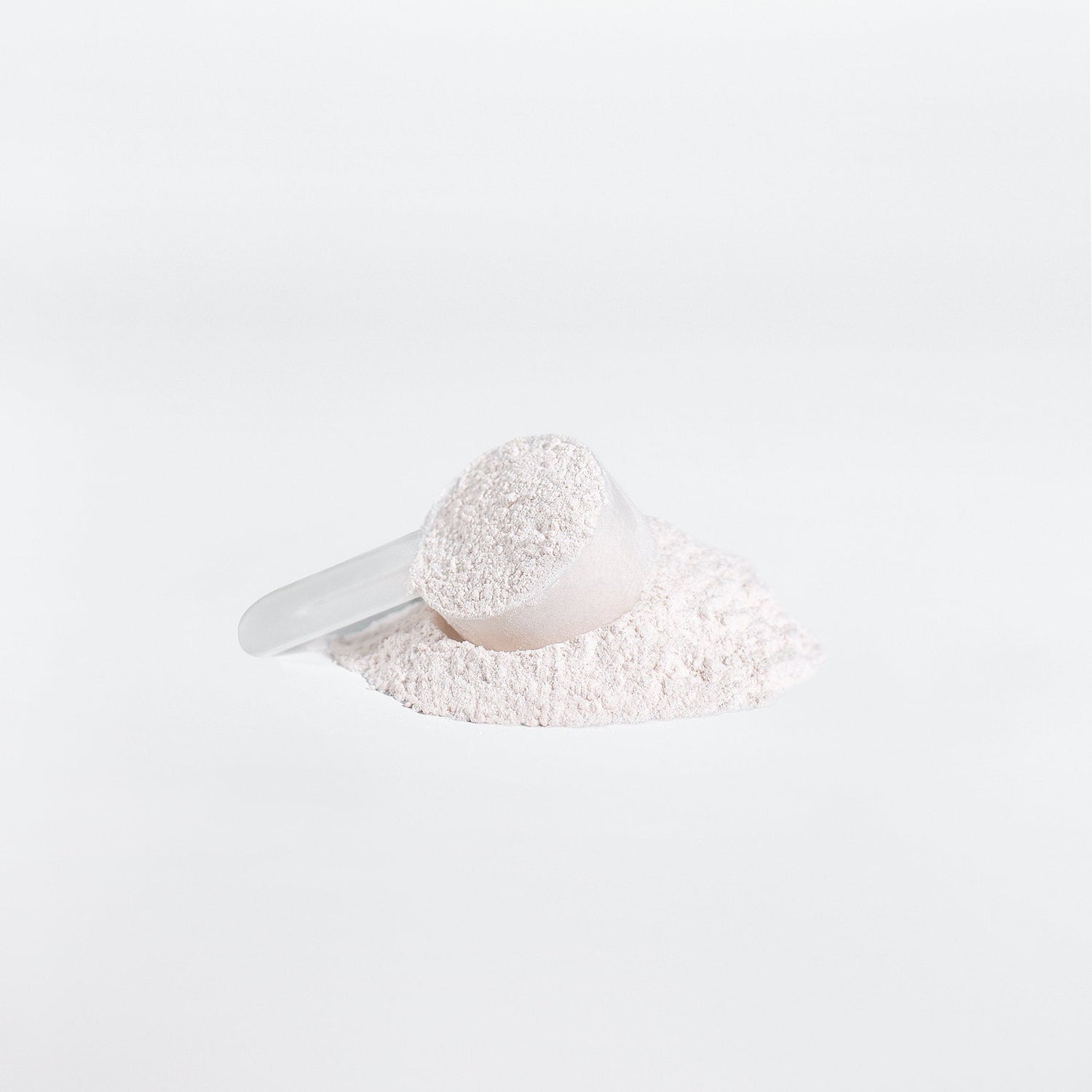 A scoop of white powdered BCAAs, ideal for rugby athletes seeking peak performance and recovery support.